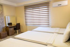 Postel nebo postele na pokoji v ubytování İkarus Hotel