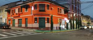 an orange building on the side of a street at HOSTAL CALIFORNIA in Quito