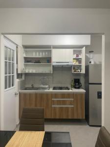a kitchen with white cabinets and a stainless steel refrigerator at Casa Regina in Gallinero