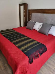 Ένα ή περισσότερα κρεβάτια σε δωμάτιο στο Suites Independencia Oaxaca