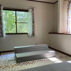 a bedroom with a bed and a window at Kitakaruizawa Morino Bessou NO6 in Kita-karuizawa