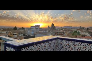 a view of a city at sunset from a building at Ático Panorama Catedral in Granada