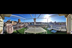 a balcony with a table and a view of a city at Ático Panorama Catedral in Granada +220 photos