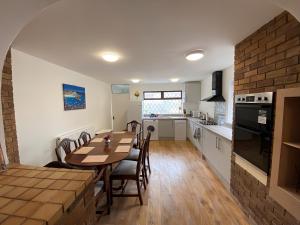 a kitchen and dining room with a table and chairs at 4-Bedroom home - Perfect for those working in Bridgend - By Tailored Accommodation in Bridgend