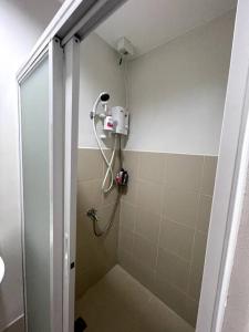 a shower with a blow dryer in a bathroom at CityView Condo w/ balcony-14 in Cagayan de Oro
