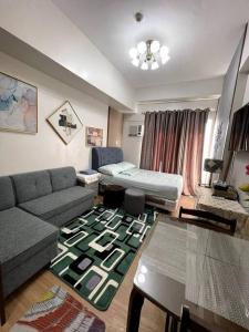a living room with a couch and a table at CityView Condo w/ balcony-14 in Cagayan de Oro