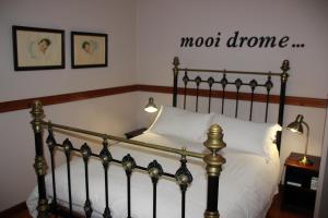 a bedroom with a bed with a mood hormone sign on the wall at Potteberg Guest Farm in Malgas