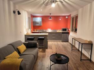 a living room with a couch and a kitchen at Ô Vive Studio in Monnetier-Mornex