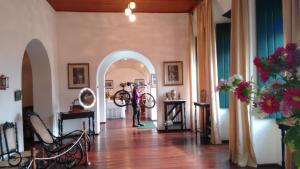 a person standing in a hallway with a bike in a room at Pousada Rio de Contas in Rio de Contas