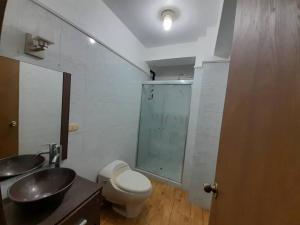 a bathroom with a toilet and a sink and a mirror at Apartamento En Valencia in Valencia