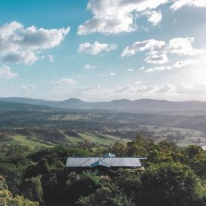 a view from the top of a hill with a barn at Luxurious Hinterland Guest House with HEATED POOL Sleeps 10 Brisbane Scenic Rim Gold Coast in Canungra