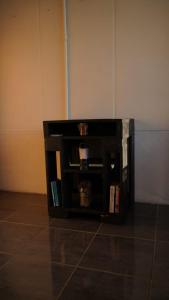 a black book shelf with books in a room at Epimoni in Poás