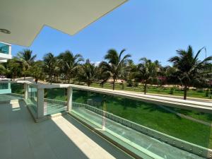 a view from the balcony of a building with palm trees at Apartaments, Mui Ne, Viet Nam in Phan Thiet