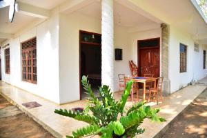 a porch of a house with a table and chairs at Rusara Villa in Tissamaharama