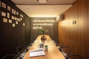 a conference room with a long wooden table and chairs at One Forest Youth Hostel - The Bund Branch in Shanghai
