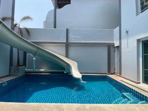 a swimming pool with a slide in a building at south pattaya,5BR modern villa in Pattaya Central