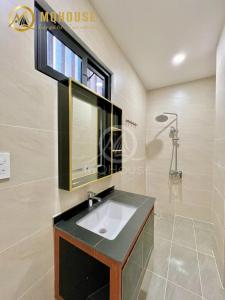 a bathroom with a sink and a window at 25A Cửu Long in Ho Chi Minh City