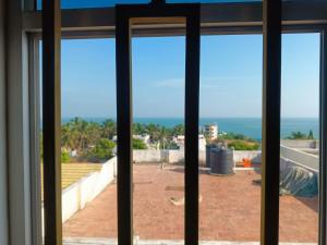 a view of the ocean from a window at HOTEL AATHANAM in Kanyakumari