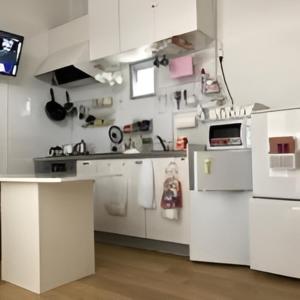 a white kitchen with white cabinets and a counter at AVAHOUSE アバハウス in Miyako-jima