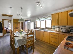 a kitchen with a table and a dining room at Pine Lodge - Uk46679 in Highley