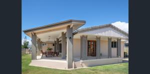 a house with a porch with a roof at Your Home at Southside Central - Family friendly. in Bundaberg