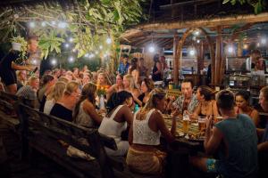 a group of people sitting in a restaurant at Begadang in Gili Islands