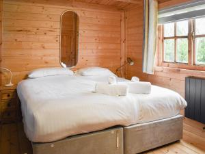 a bedroom with a large bed in a wooden room at Pineville in Dover