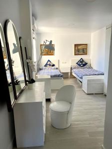 a room with two beds and a mirror at Rare find! Skyline view-Modern 6 bed 2 bath flat in the heart of Málaga in Málaga