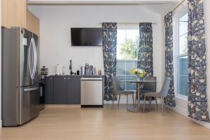 a kitchen and dining room with a table and a refrigerator at Hollywood Family Nest in Burbank, Steps to Studios! in Burbank +13 photos
