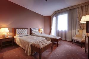 Postel nebo postele na pokoji v ubytování Borgo Palace Hotel + 19 fotografií