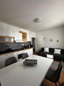 a kitchen and living room with a table and chairs at Apartments Vukovic in Selce
