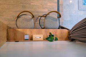 a shelf with two chairs in a waiting room at Kaso Urban Villa in Yogyakarta +6 photos