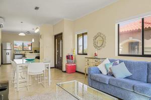 a living room with a blue couch and a table at wonder apartment in gold coast with private pool in Palm-Eagle Beach