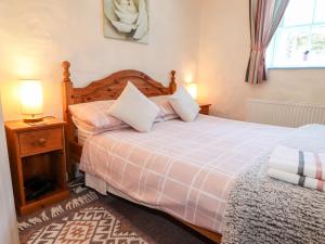 a bedroom with two beds and two lamps and a window at Casa Mia in Goodwick