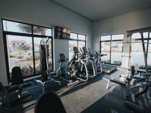 a gym with a bunch of bikes in a room with windows at Spectacular house in gold coast in Palm-Eagle Beach