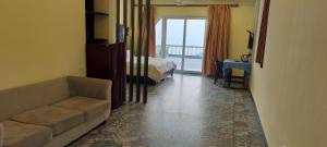 a living room with a couch and a bed at Sea view Sun shine in Calangute