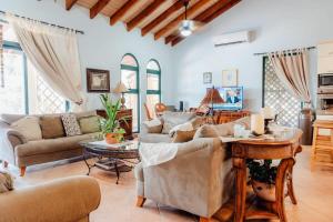 a living room with couches and a table at The elegance of Tierra del Sol with private pool in Palm-Eagle Beach