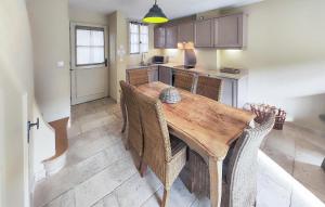 a kitchen with a wooden table and some chairs at Lovely Home In Stlaurent-De-La-Cabr in Saint-Laurent-de-la-Cabrerisse