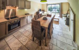 a kitchen with a wooden table and chairs in a room at Lovely Home In Stlaurent-De-La-Cabr in Saint-Laurent-de-la-Cabrerisse