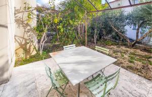 a white table and chairs on a patio at Lovely Home In Stlaurent-De-La-Cabr in Saint-Laurent-de-la-Cabrerisse +18 photos