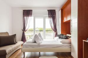 a living room with a couch and a window at Apartments and Rooms Michaela in Fažana