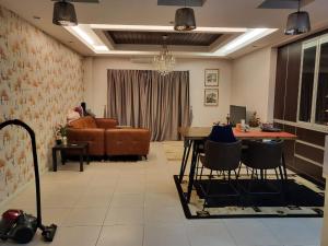 a living room with a table and a couch at T&S Homestay in Puchong