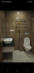 a bathroom with a toilet and a sink at Hotel Ganga Amrit Haridwar Near Railway Station in Haridwār