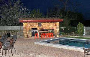 a patio with a bar with chairs and a pool at La Recre Dempurany in Empurany +35 photos