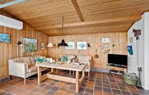 a living room with a table and a couch at Nice Home In Rudkbing With Wifi in Spodsbjerg