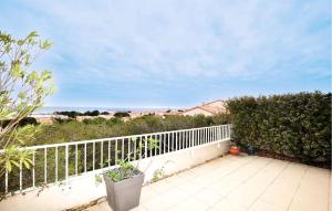 a balcony with a white fence and a view of the ocean at Stunning Home In Saint Pierre La Mer in Saint Pierre La Mer