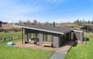 a tiny house with a deck in a field at Nice Home In Haderslev With Wifi in Haderslev