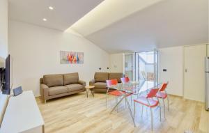 a living room with a glass table and chairs at 2 Bedroom Amazing Apartment In Moneglia in Moneglia +12 photos