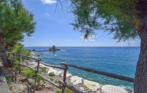 a view of the ocean with a wooden fence at 2 Bedroom Amazing Apartment In Moneglia in Moneglia