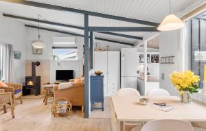 a kitchen and living room with a table and chairs at 3 Bedroom Awesome Home In Dannemare in Dannemare